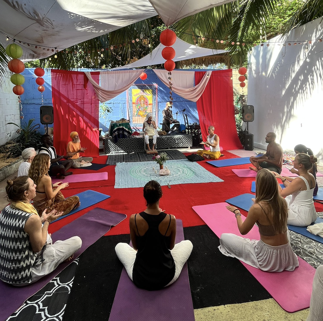 A daytime Kirtan circle under the palapa in the Ganesha's Lounge garden